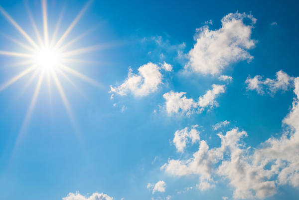 image of a blue sky with clouds and sun