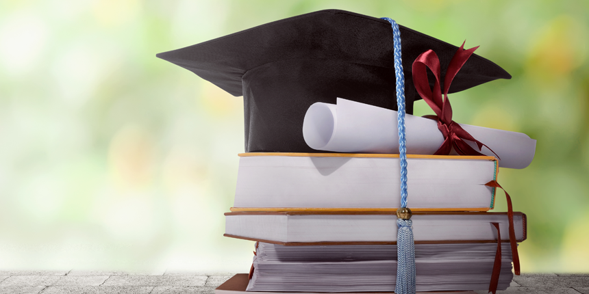 Graduation hat on top of stacked books and university or college degree or diploma 