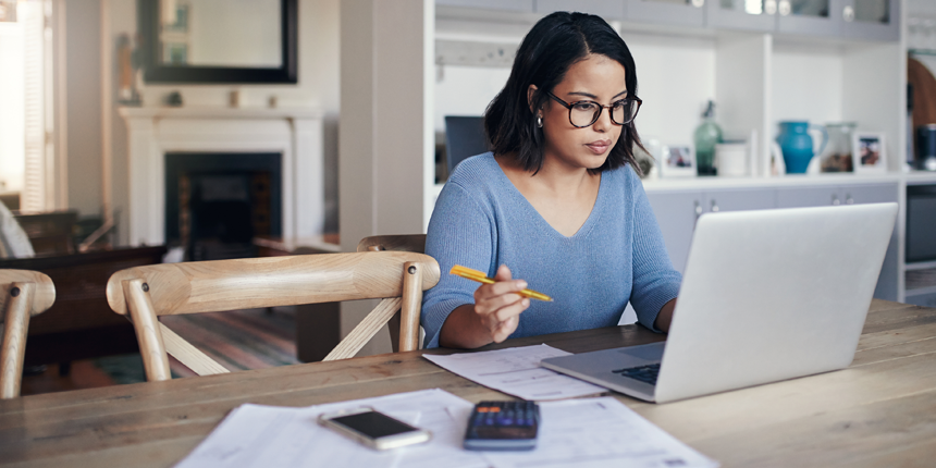 Shot of a young woman using a laptop while working from home