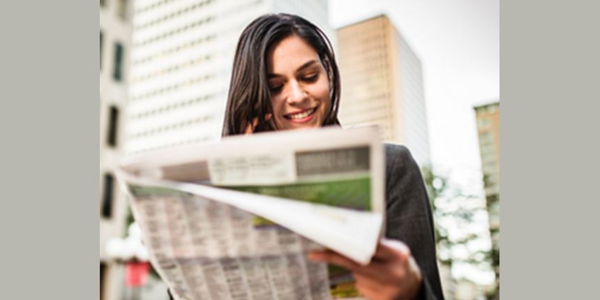 Woman reading newspaper for Top stories 4x2