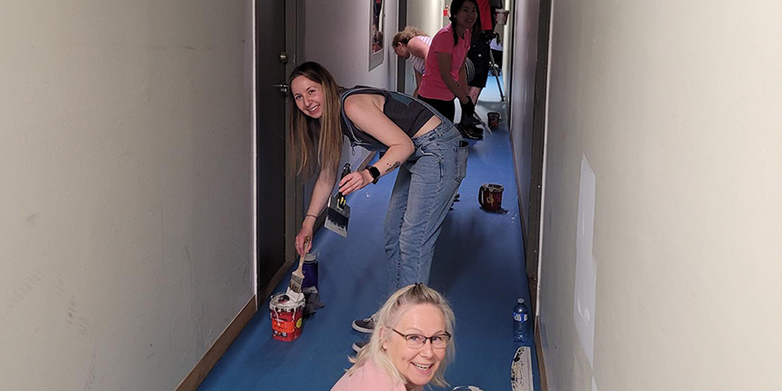 Volunteer painters at work in a corridor