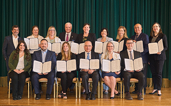 Regulator representatives posing each with an open document