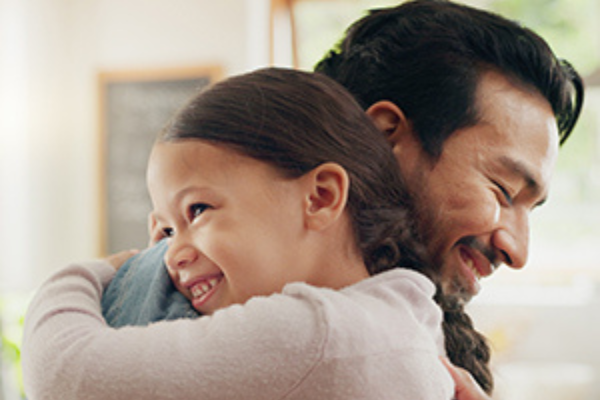 Image of a father and child hugging