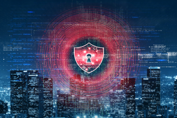 A digital concept image representing cybersecurity, showing a glowing red security shield with a keyhole overlaid with circular digital circuitry and binary data above an illuminated modern cityscape at night.