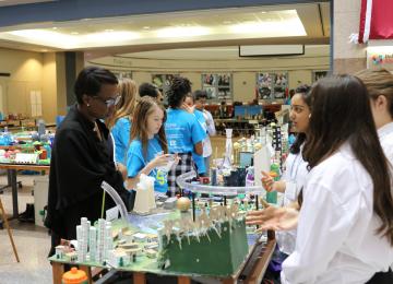 Students showing their Future City model to other students