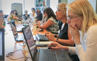 a group of volunteers using laptops