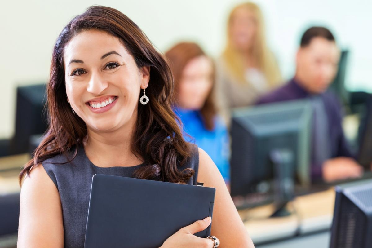 woman smiling hold a laptop