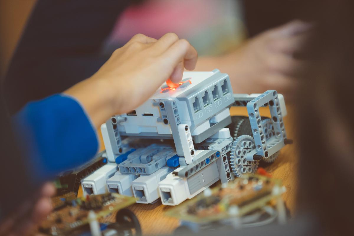 girls hands working on technical lego item