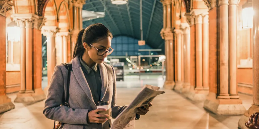 women reading newspaper in grand hall