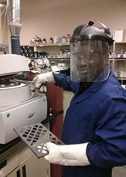 a person wearing a face shield and gloves