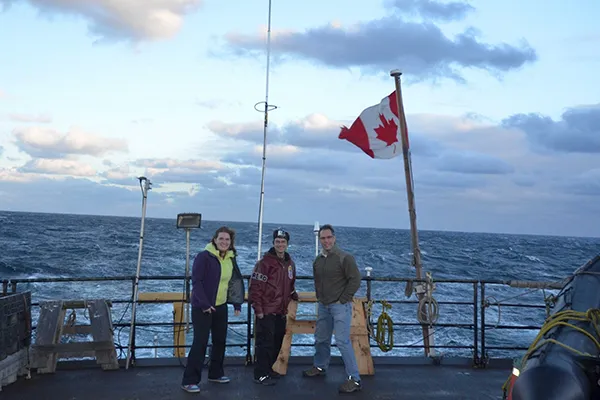 Engineers on deck of ship at sea