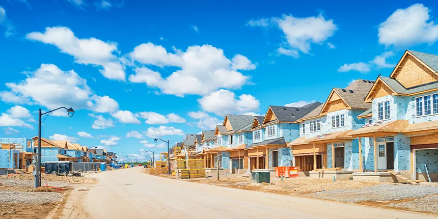 Construction site with unfinished homes along a road
