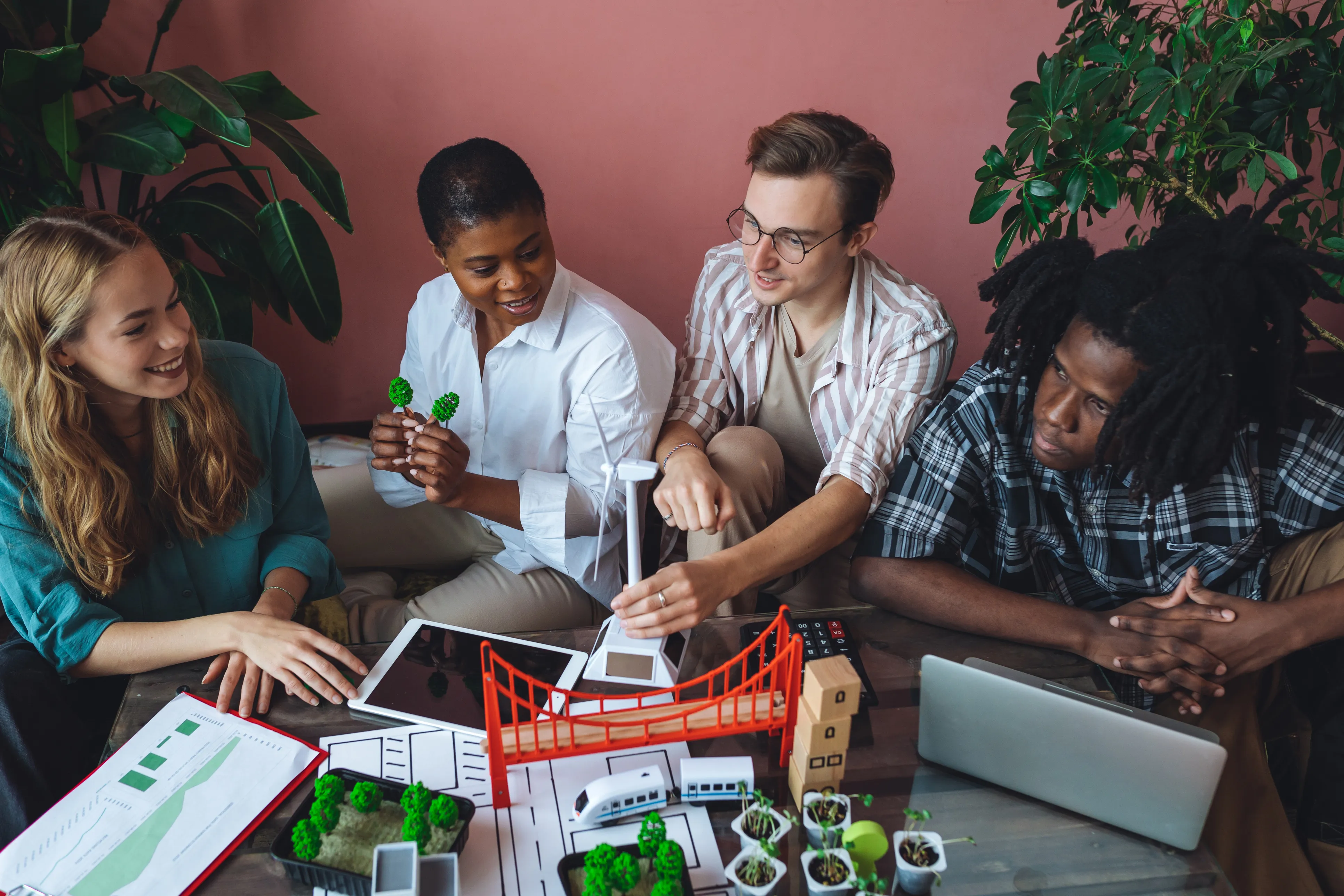 seated group of people holding small engineering models