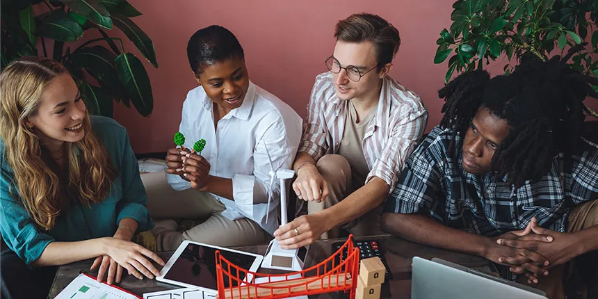 Seated group of people holding small engineering models